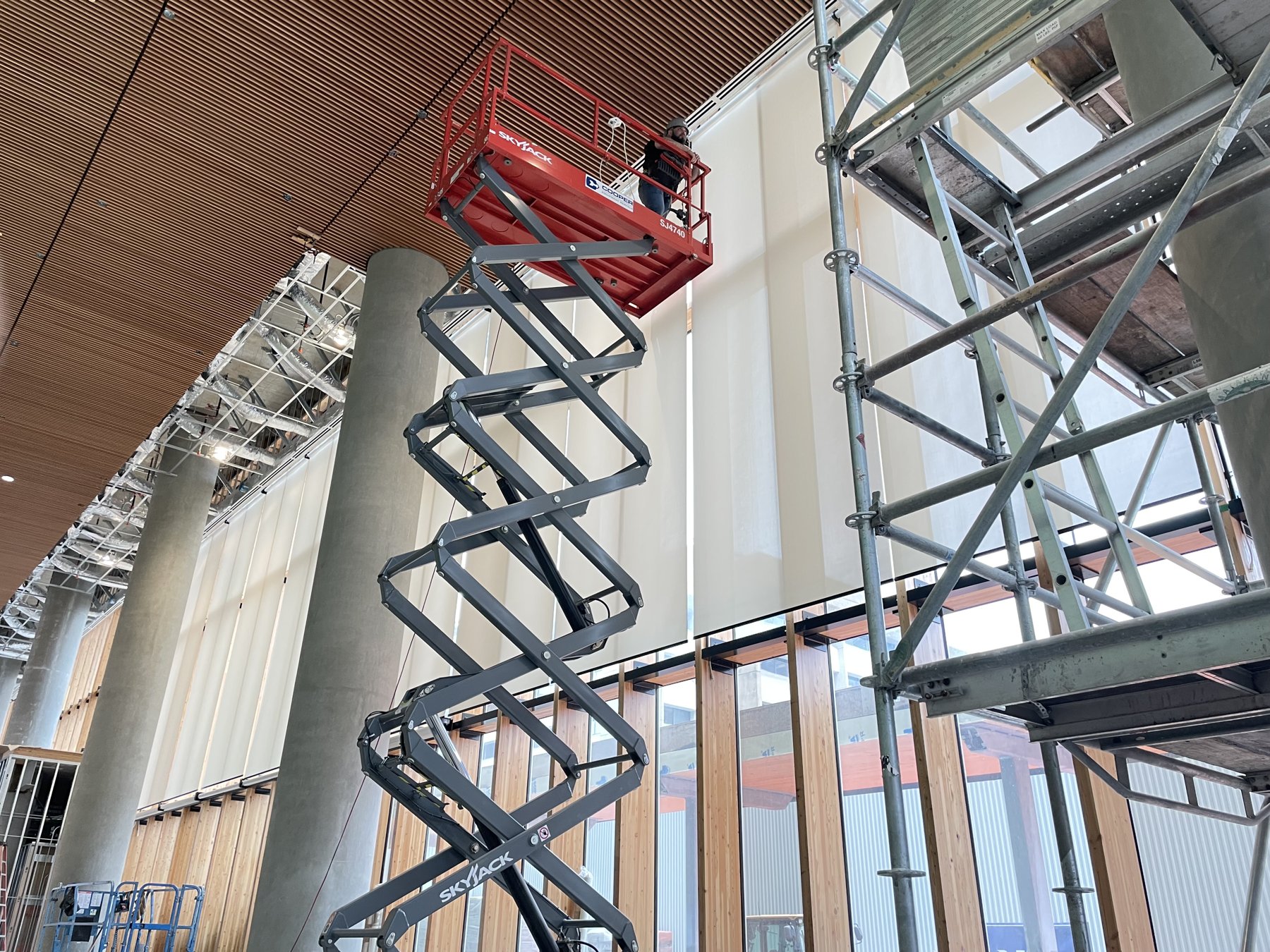 Large-scale commercial shade installation on scissor lift