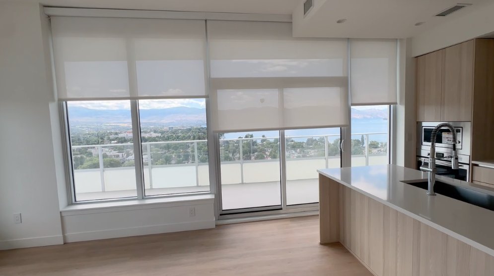 Roller shades in a kitchen with a lake view